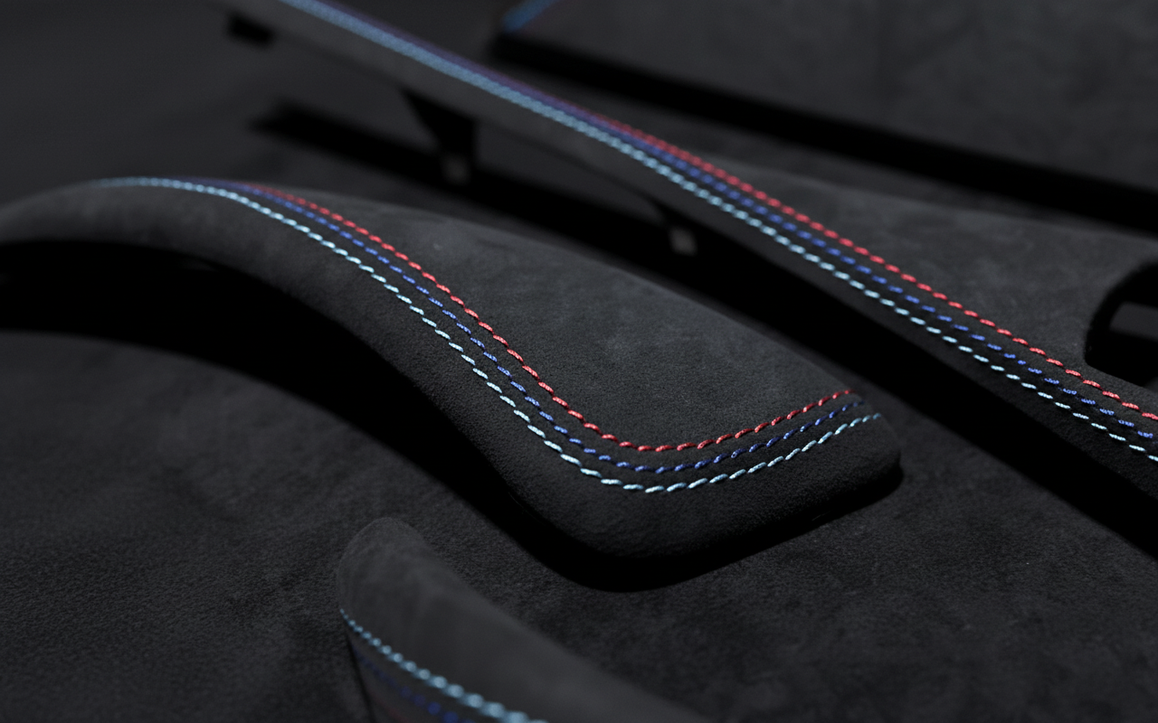 Macro shot of BMW 1 & 2 Series F21 F22 F23 F87 Alcantara Interior Trim with Tricolor Stitching