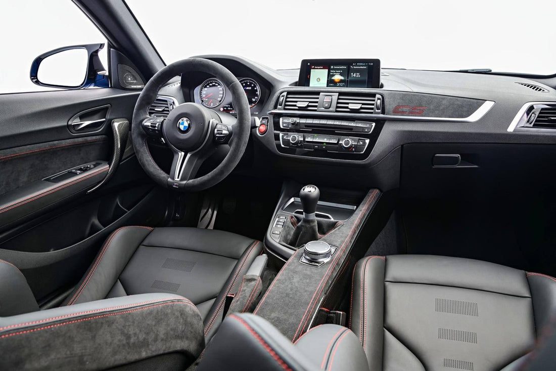 Wide-angle BMW interior with Alcantara-wrapped seats and trim