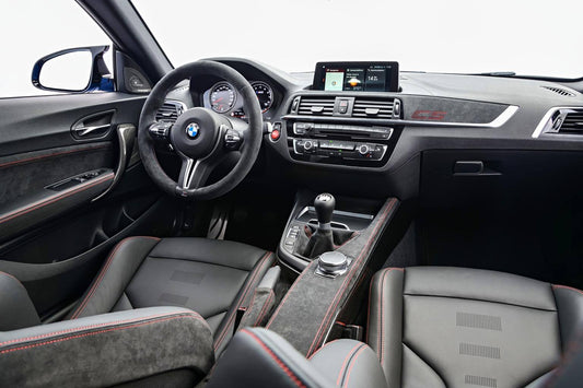 Wide-angle BMW interior with Alcantara-wrapped seats and trim