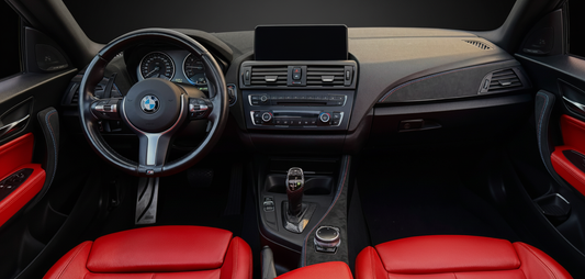 Wide-angle view of a BMW interior featuring Alcantara-wrapped trim and steering wheel, showcasing premium customization and modern OEM appeal.