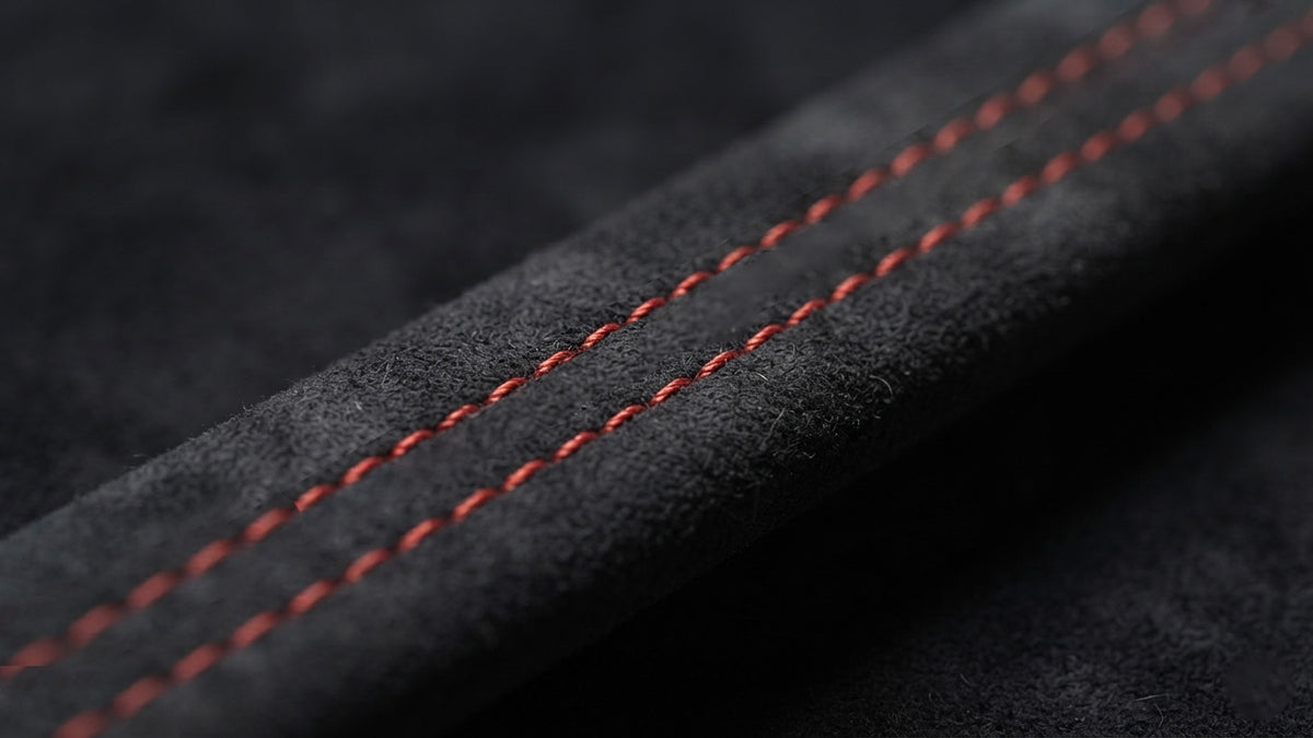 Macro shot of AUDI A3/S3/RS3 genuine Alcantara interior trim with red stitching