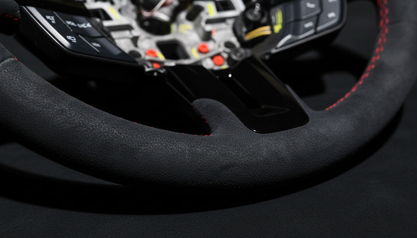 Macro shot of FORD MUSTANG 2018-2023 Alcantara Steering wheel with gloss black finish - Red Stitching